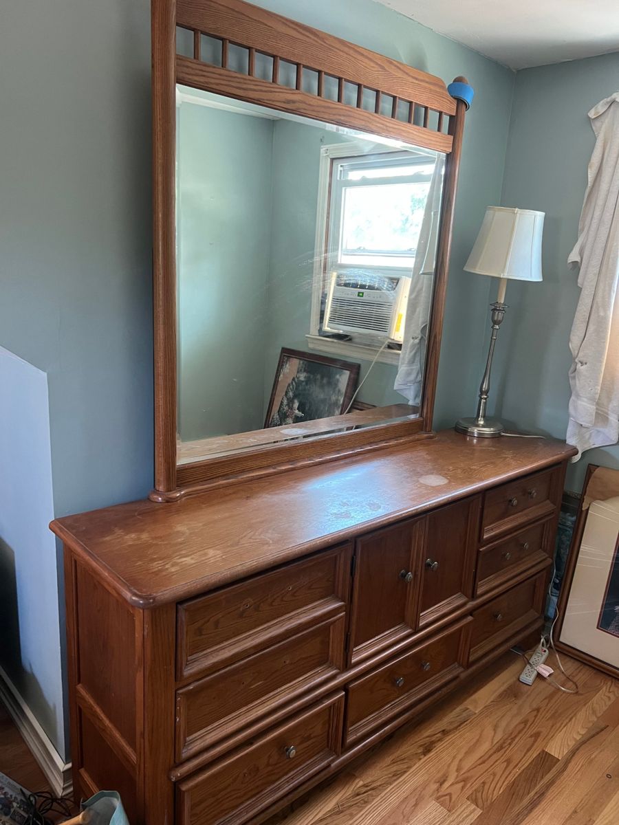 Oak dresser with a mirror in a bedroom