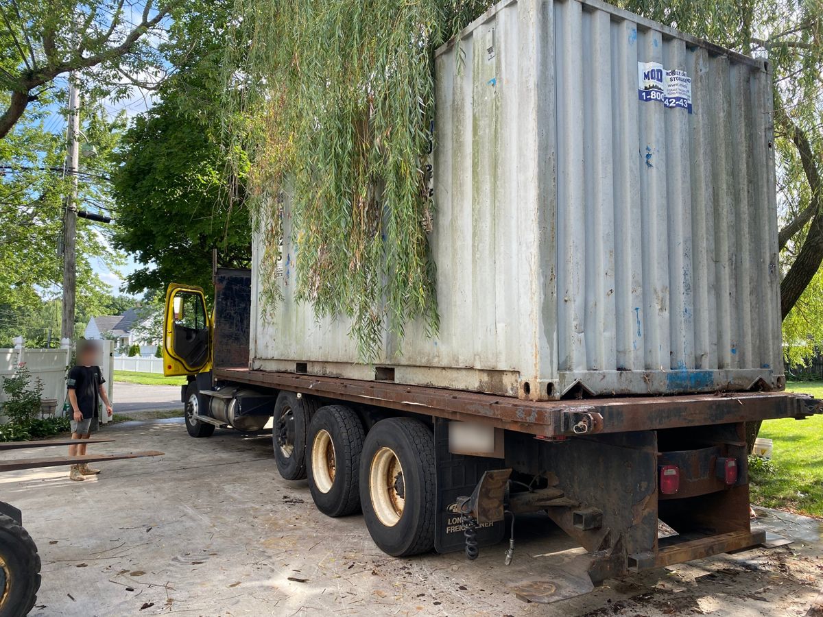Steel storage container loaded on a flatbed truck