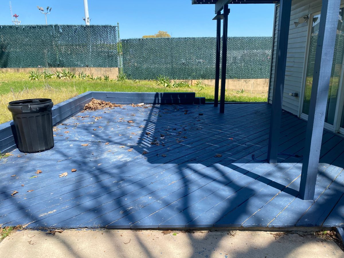 Backyard deck swept clear after the junk was removed