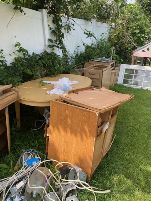 Round table and cabinets sitting in a backyard